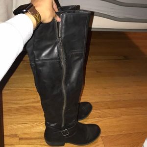 Knee high black boots.